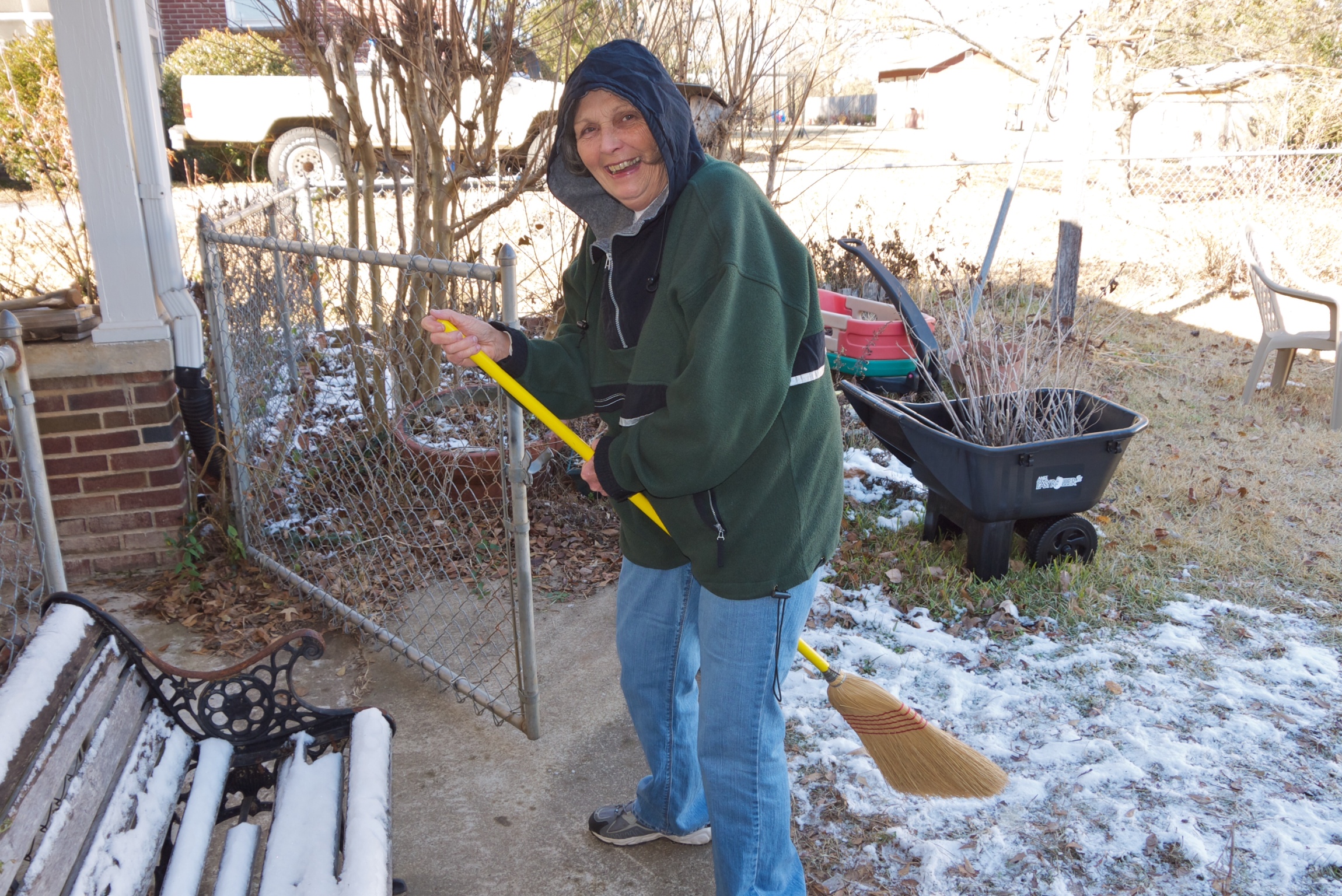 Susie sweeping outside the house